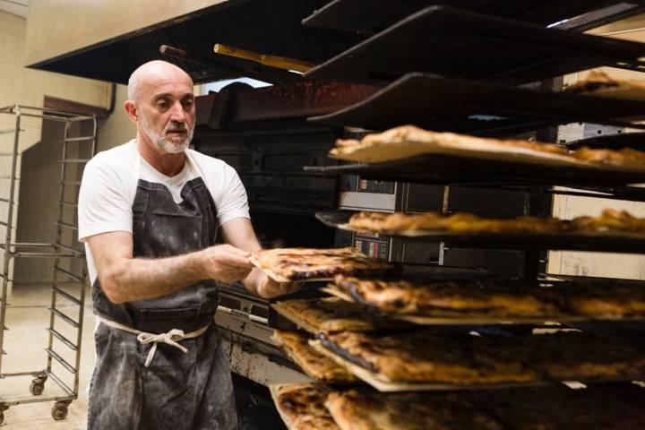 José Luis sacando del horno los empanadicos para que reposen.