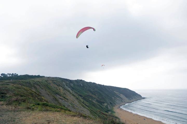 Cuando hay suficiente viento el parapente baja planeando hasta la playa de Sopelana.