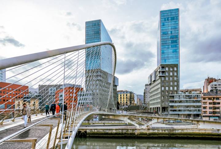 Bilbao, Spain - January 2, 2024: The Zubizuri footbridge designed by Santiago Calatrava over the Nervion River in Bilbao, Spain