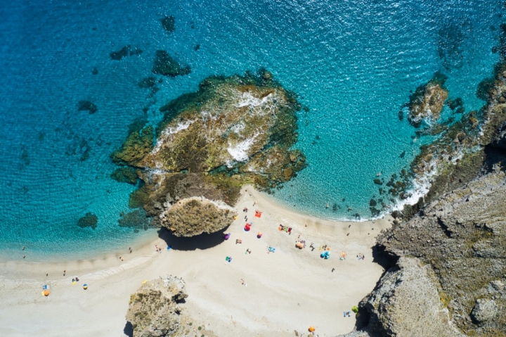 Aerial of the crowded cove beach. Beach of the dead. Almeria, Spain.